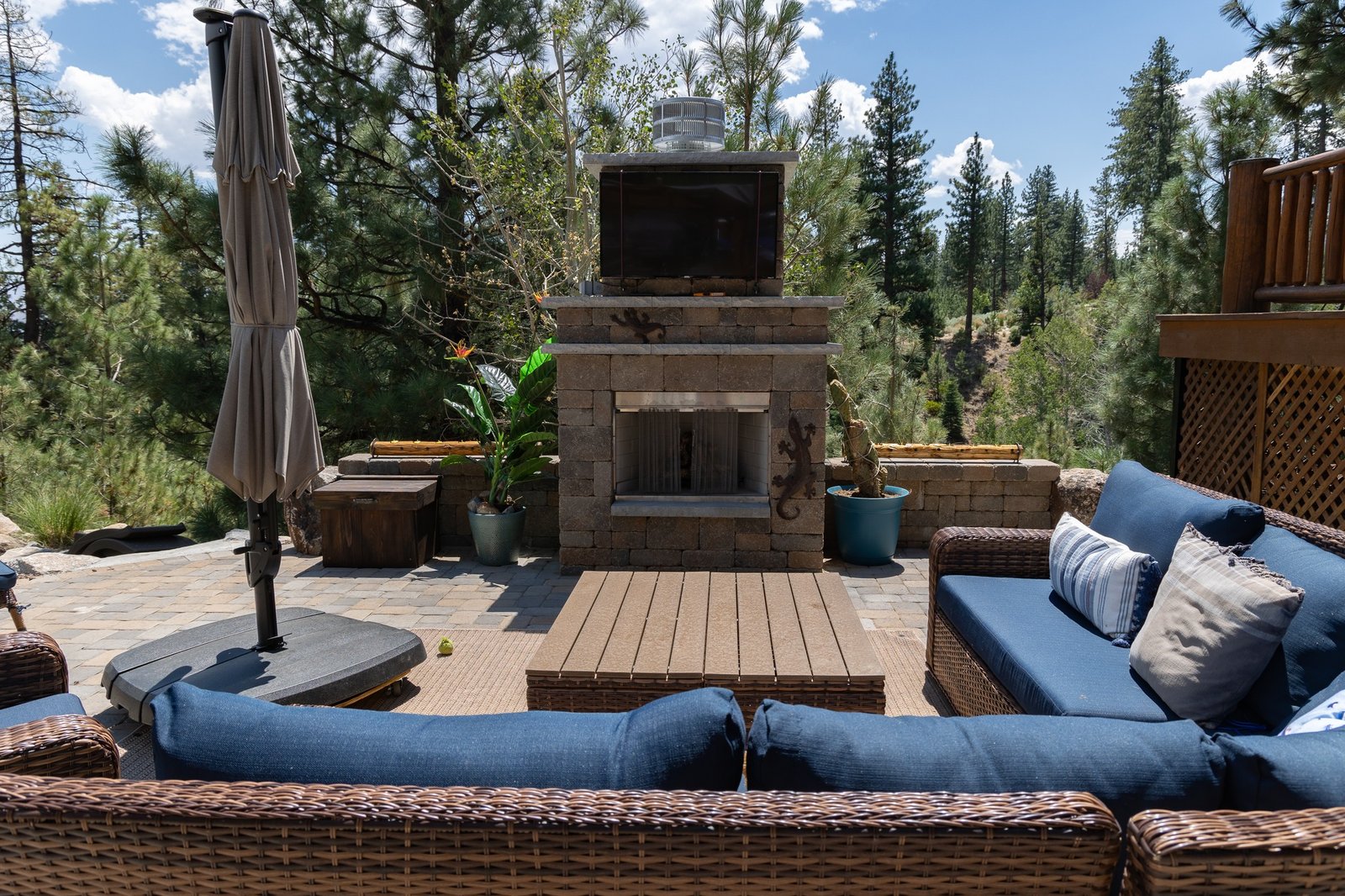 Design Build Outdoor fireplace with couch surround on paver patio gail willey landscaping