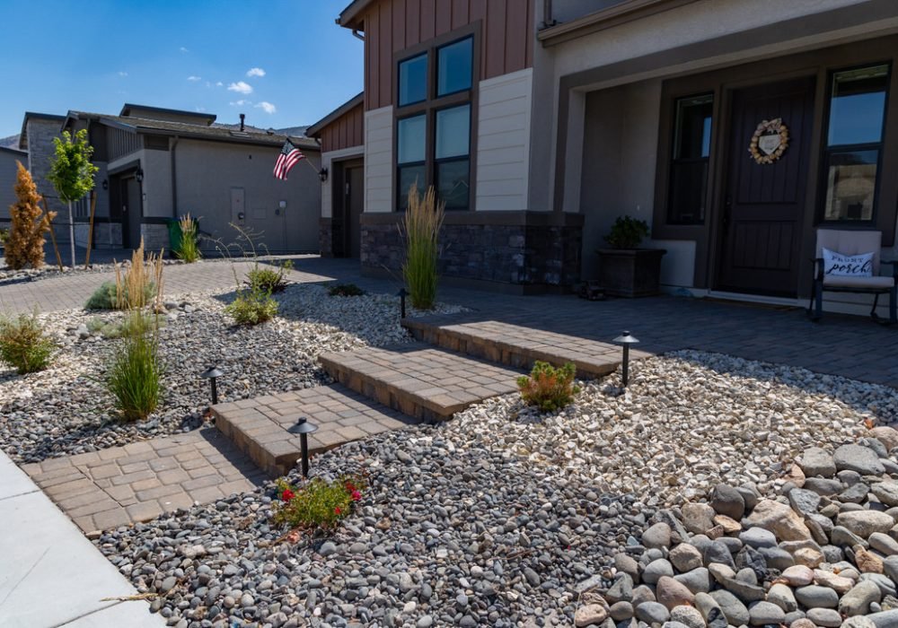 Xeriscape landscaping with pavers, dry creek, and artificial turf, and water wise plants
