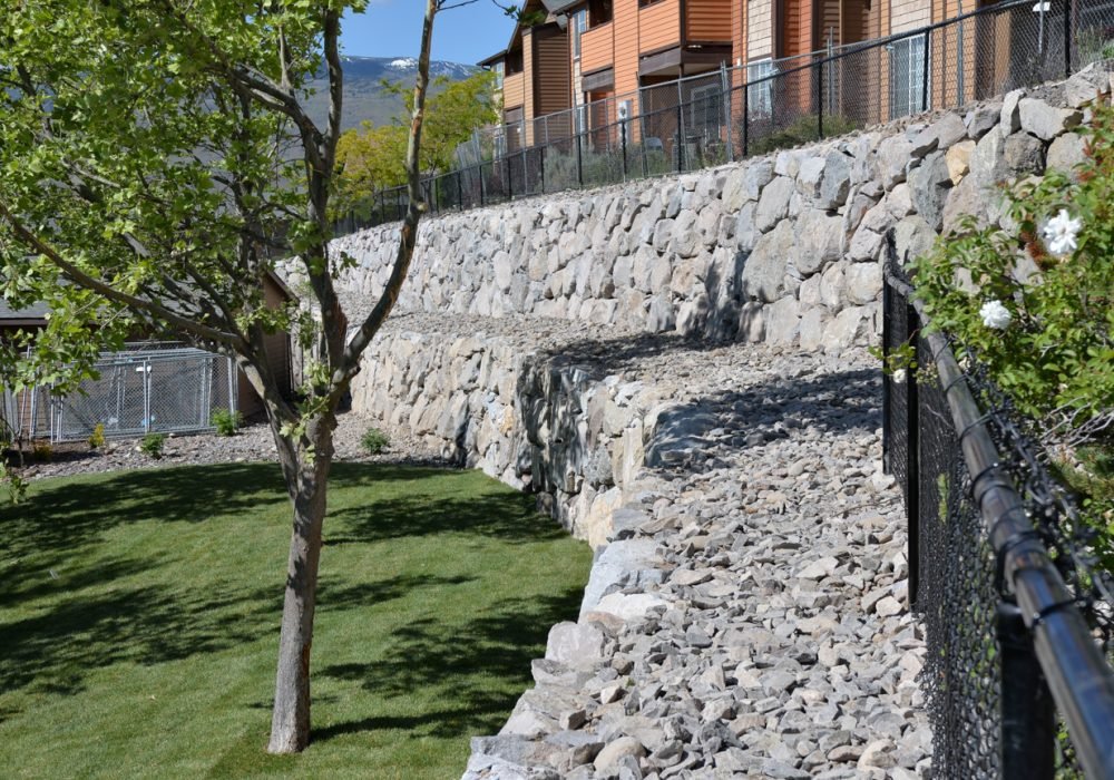 Engineered dry stack boulder retainer walls for commercial or residential properties.