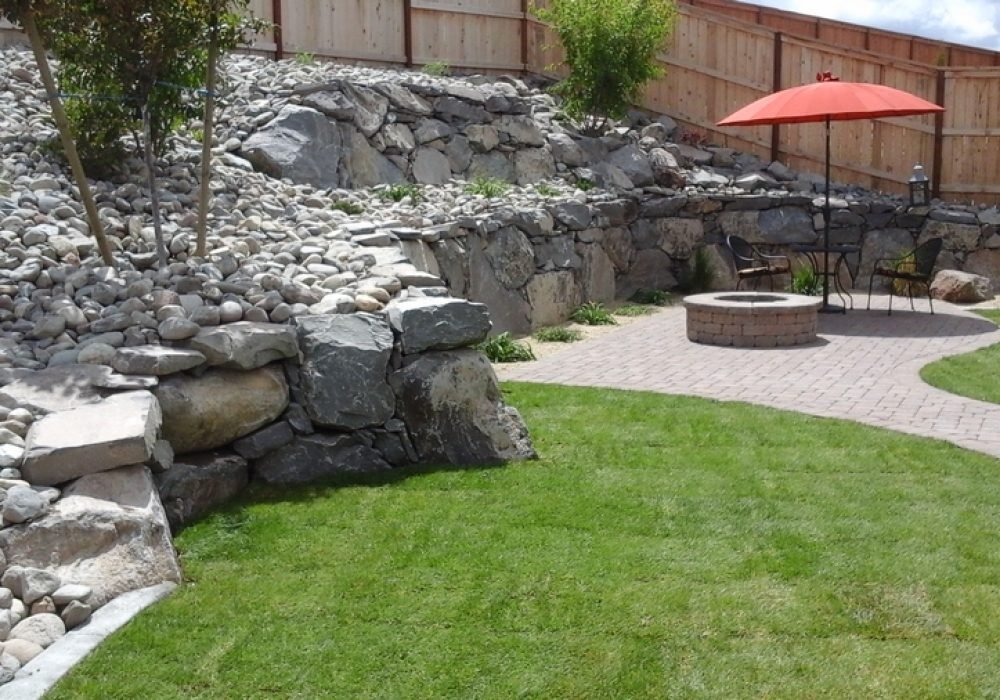 Engineered dry stack boulder retainer wall for commercial or residential properties.